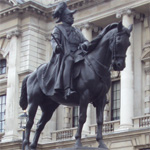 `Naked’ man straddles Prince George’s statue in London