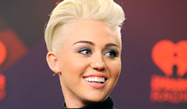 Miley Cyrus dances with topless stripper at Hollywood concert