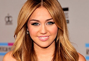 Miley Cyrus dances with topless stripper in shocking concert