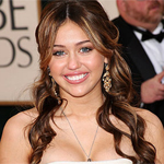 Who is Miley Cyrus sharing her bed with?