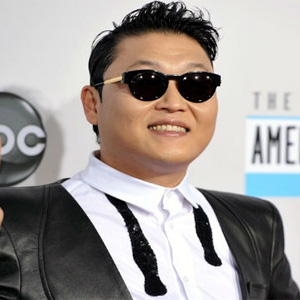 Psy mounts fake white horse for ad